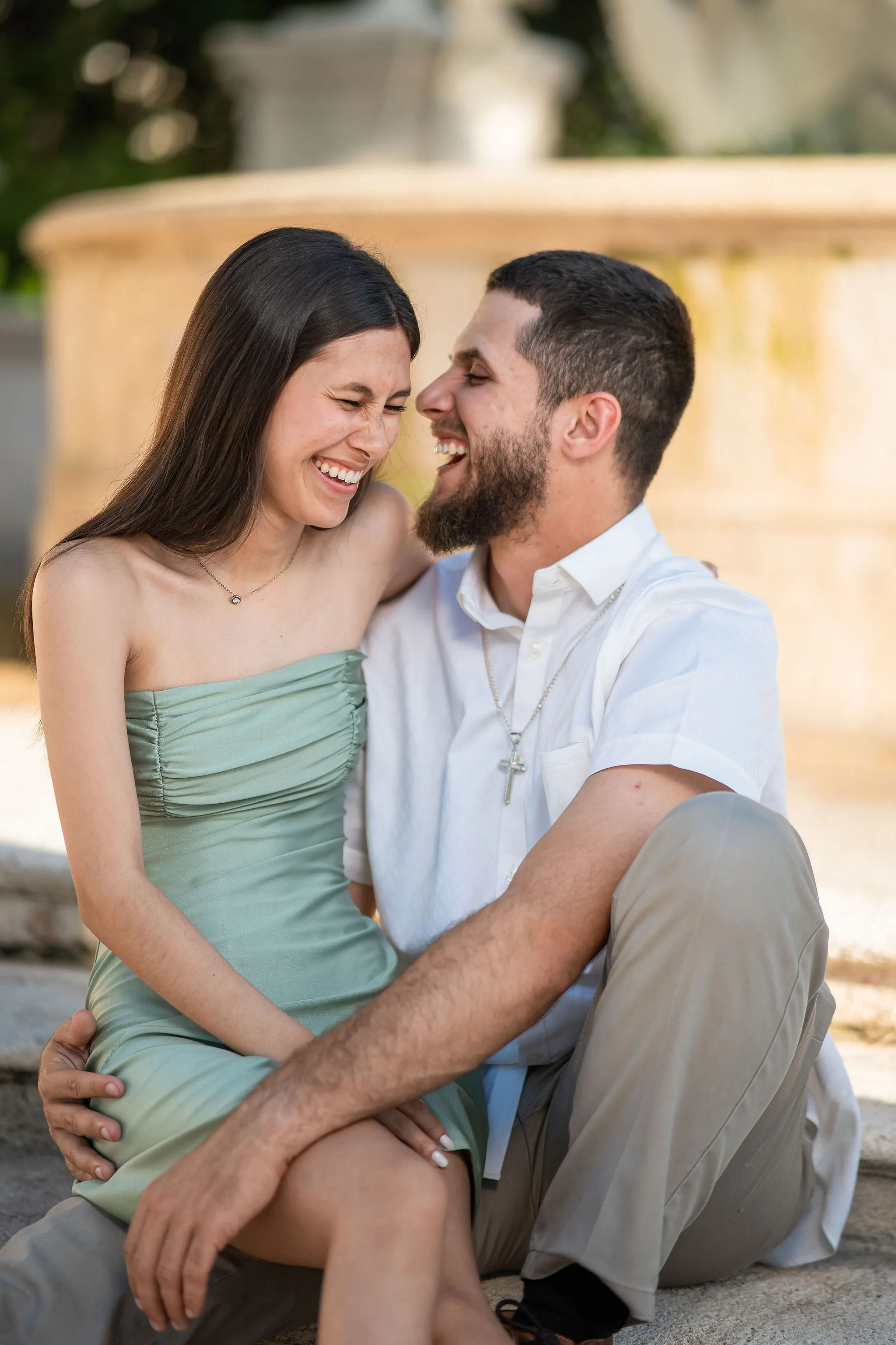 stunning silhouette photo of a couple at sunset - golden hour wedding photos A couple shares a joyful moment in an outdoor setting during golden hour.